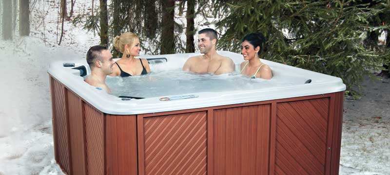 Couples enjoying QCA Spa with Dura-Frame Cabinet